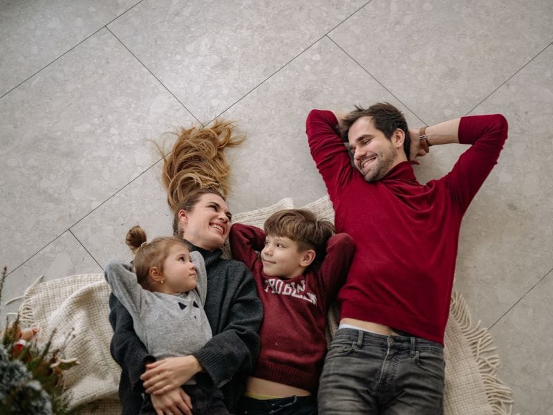 famiglia sdraiata sul pavimento della nuova casa